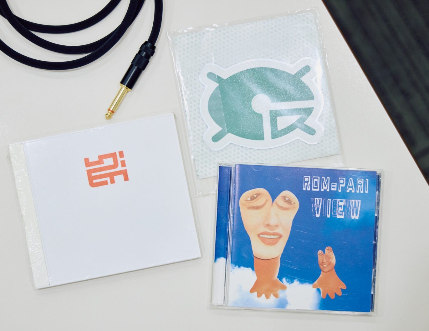 「いつか自分たちのレーベル『ギャル』からも卵ロゴのCDだったり、変わり種のフィジカルを出したいです。ただ、パソコンで読み込んだら一生取り出せなくなるんですけどね（笑）」とcpが話す、二人が20代前半の時に聴いていた作品。キネスツェシアの1stとボカム・ウェルトの変形CD、日本人兄弟デュオRom＝Pariの1st。