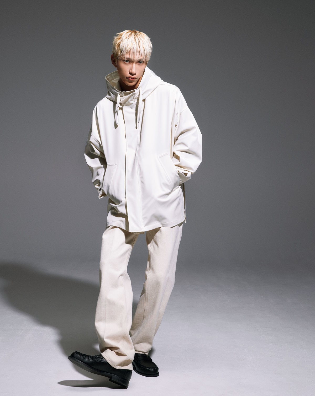 「真っ白コーデって、可愛らしいですよね。我ながら金髪に合います(笑)。アウターは柔らかで、脇のボタンを開けるとポンチョみたいになって、いろんなレイヤードが楽しめそう」。コート ¥231,000、パンツ ¥53,900、シューズ ¥100,100(以上エンポリオ アルマーニ | ジョルジオ アルマーニ ジャパン)