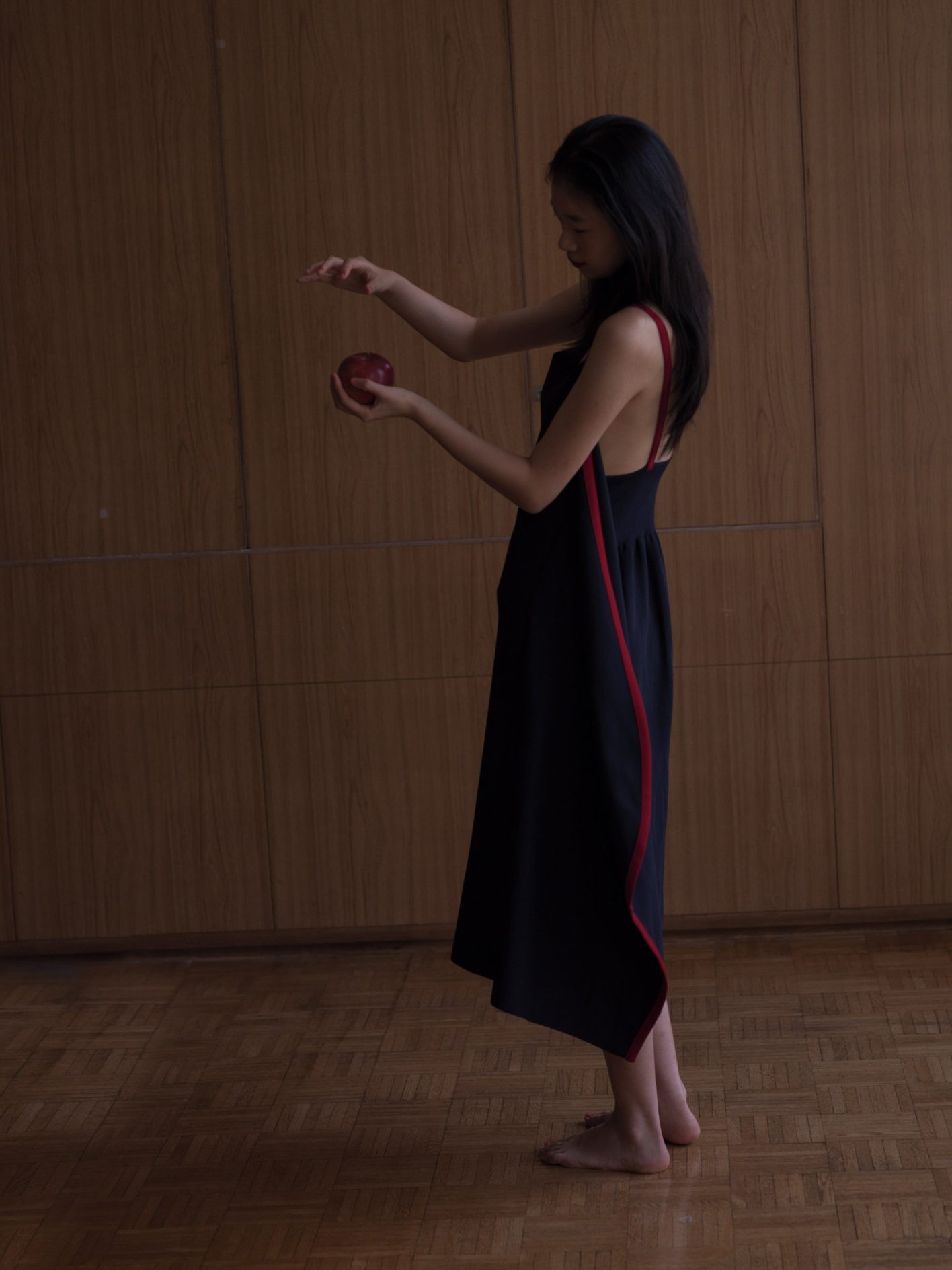 ミラノリブで仕立てられた、柔らかなハリ感と軽やかさが魅力のエプロンドレス。緩やかなカーブを描くサイドパネルのアウトラインや、ショルダーストラップの赤いラインにハッとする。「自然からの恵みのような有機的で流れる優雅なフォルムにも惹かれます」(井伊さん)。ウエストの背面には、編み続きのリブが施され快適な着心地も実現。ドレス ¥71,500(シーエフシーエル)